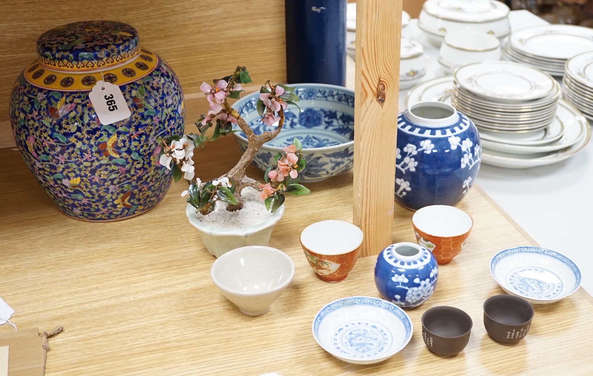 A group of various Chinese ceramics, to include a blue and white prunus jar, an earthenware dish, a famille rose jar and cover and others
